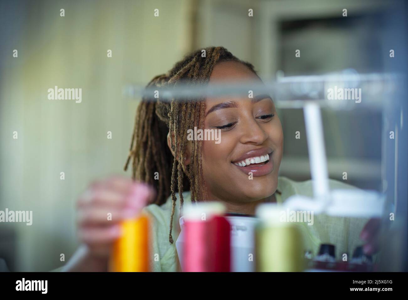 Happy young female seamstress Stock Photo