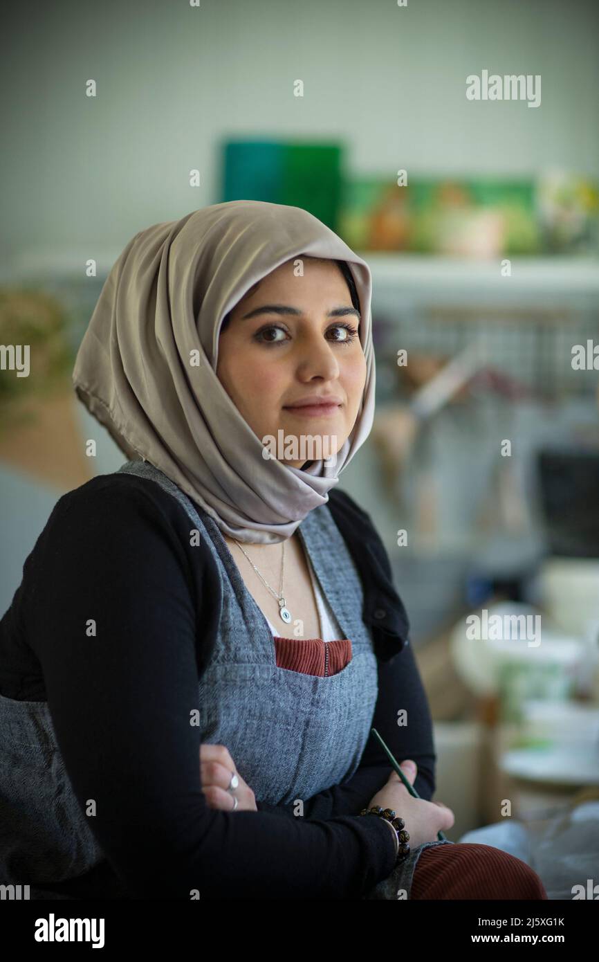 Portrait confident young female Muslim artist in hijab Stock Photo Alamy