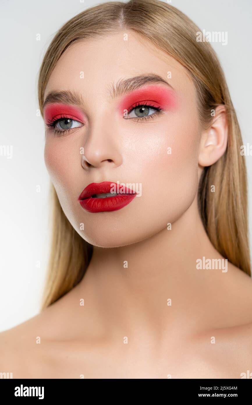 Portrait of pretty model with red makeup looking away isolated on grey Stock Photo