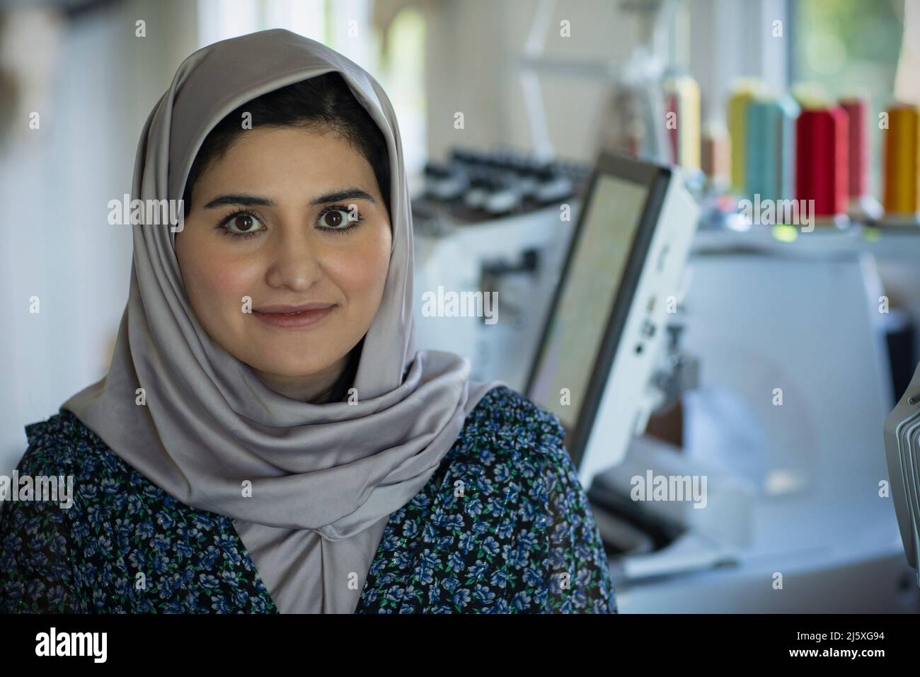 Portrait beautiful young female seamstress in hijab Stock Photo