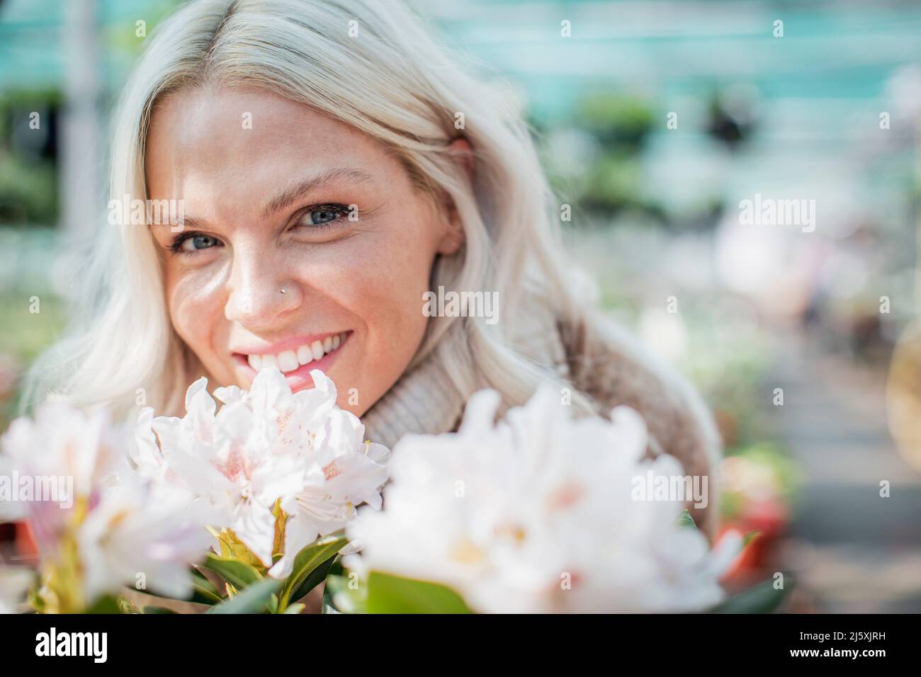 Close up portrait happy woman with flowers Stock Photo