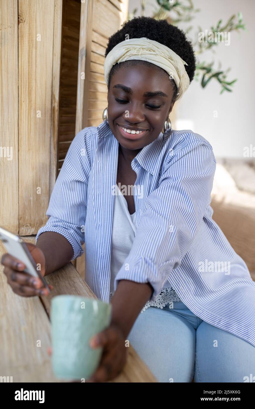 A good-looking african woman in light clothes Stock Photo