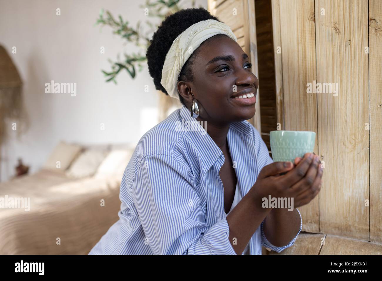 A good-looking african woman in light clothes Stock Photo