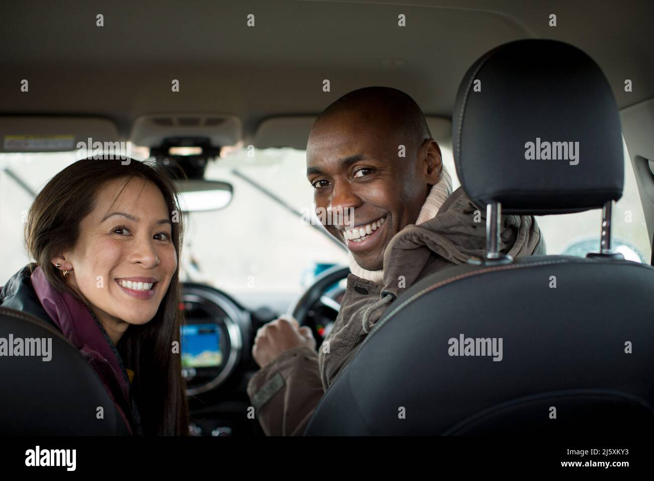 Portrait happy couple inside car Stock Photo