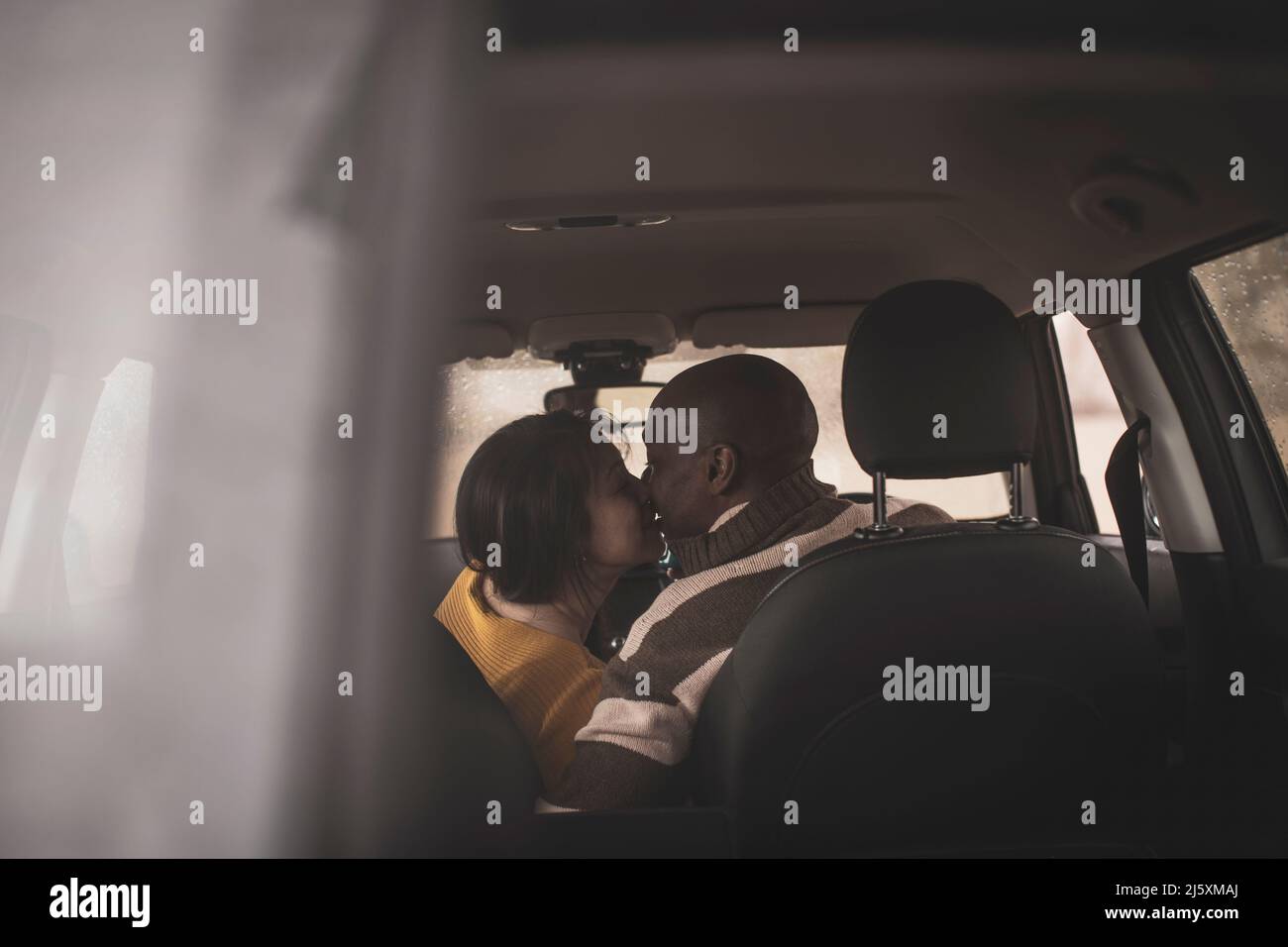 Couple kissing in car Stock Photo