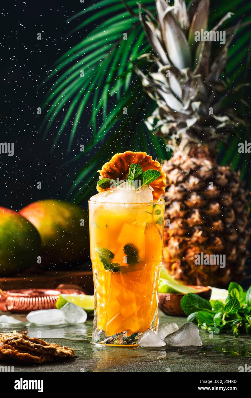 Summer cocktail with vodka, pineapple juice, mango, ice. Long drink or cold mocktail. Frozen