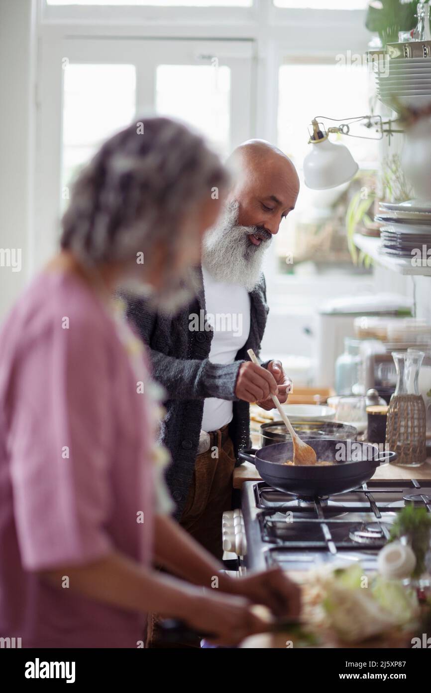 Couple cooking at kitchen stove Stock Photo