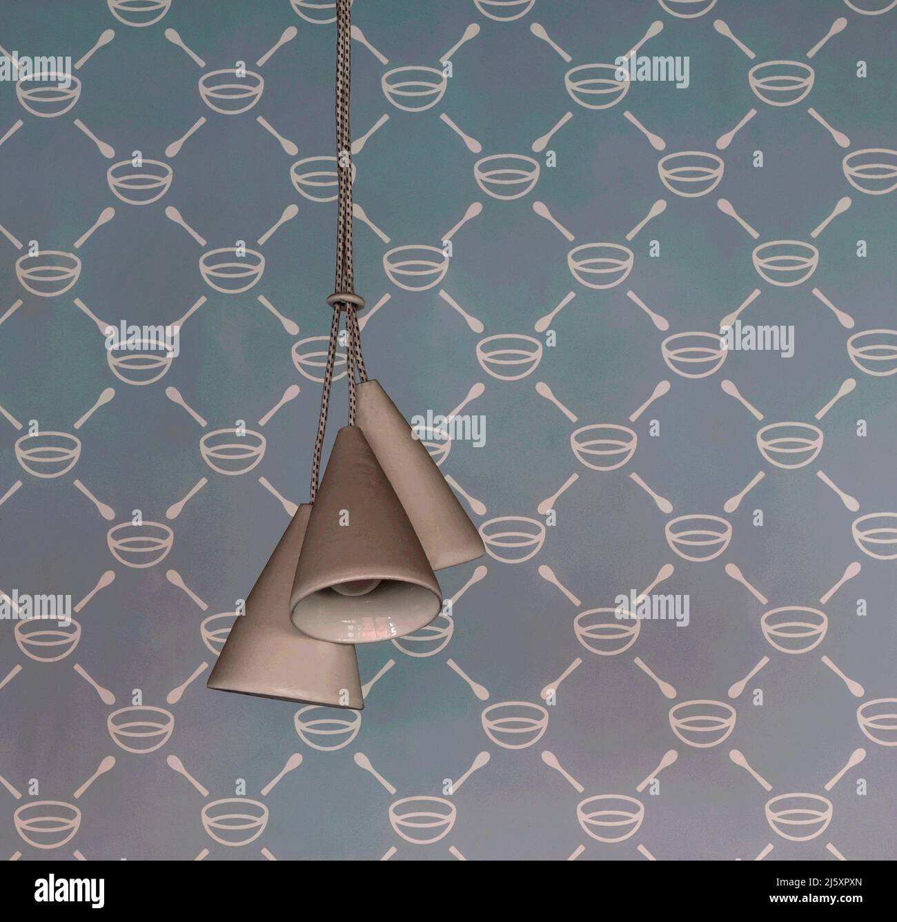 Digitally enhanced photo of three retro style hanging lamps against a blue pattern wallpaper design Stock Photo