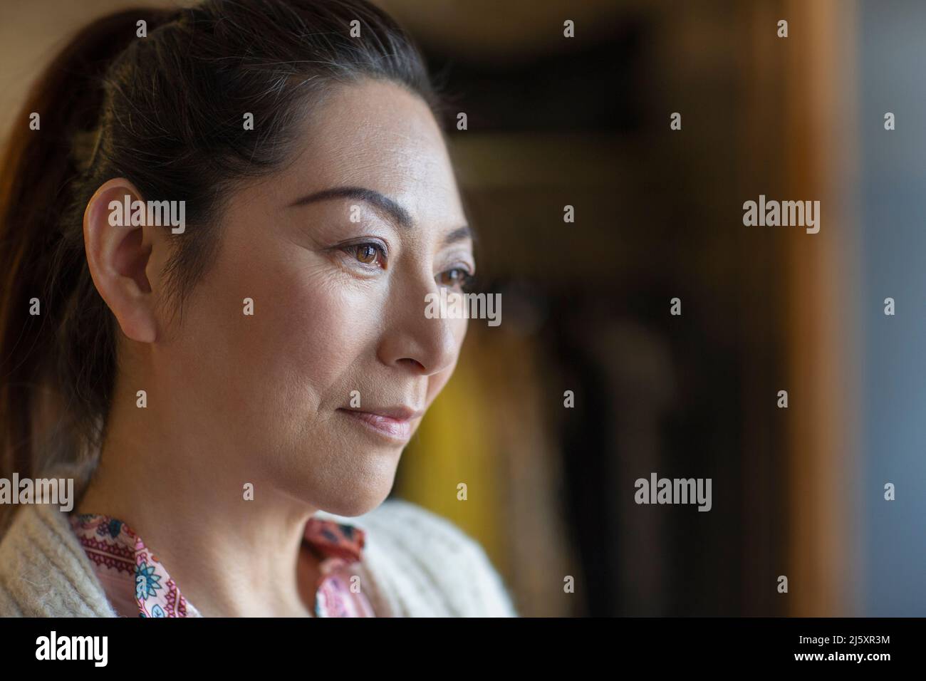 Close up portrait thoughtful woman looking away Stock Photo