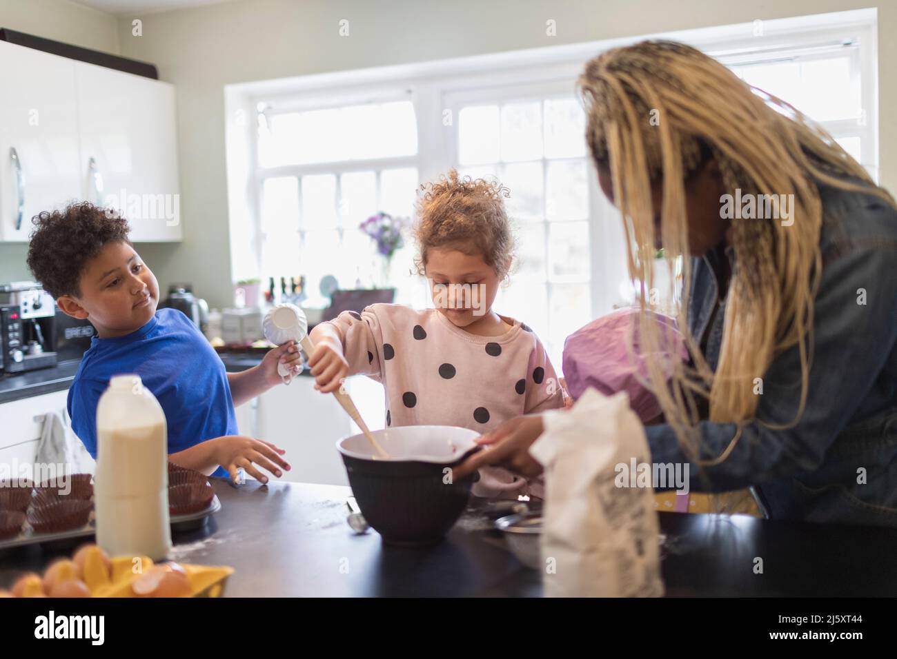 Mother and kids baking in kitchen Stock Photo