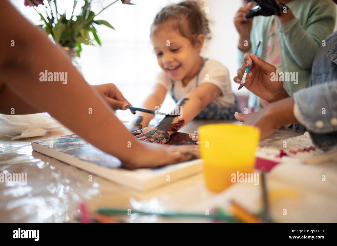 Family finger painting at table Stock Photo