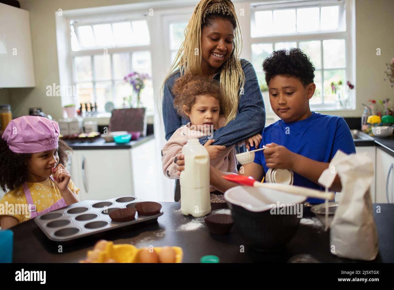 Mother and kids baking in kitchen Stock Photo