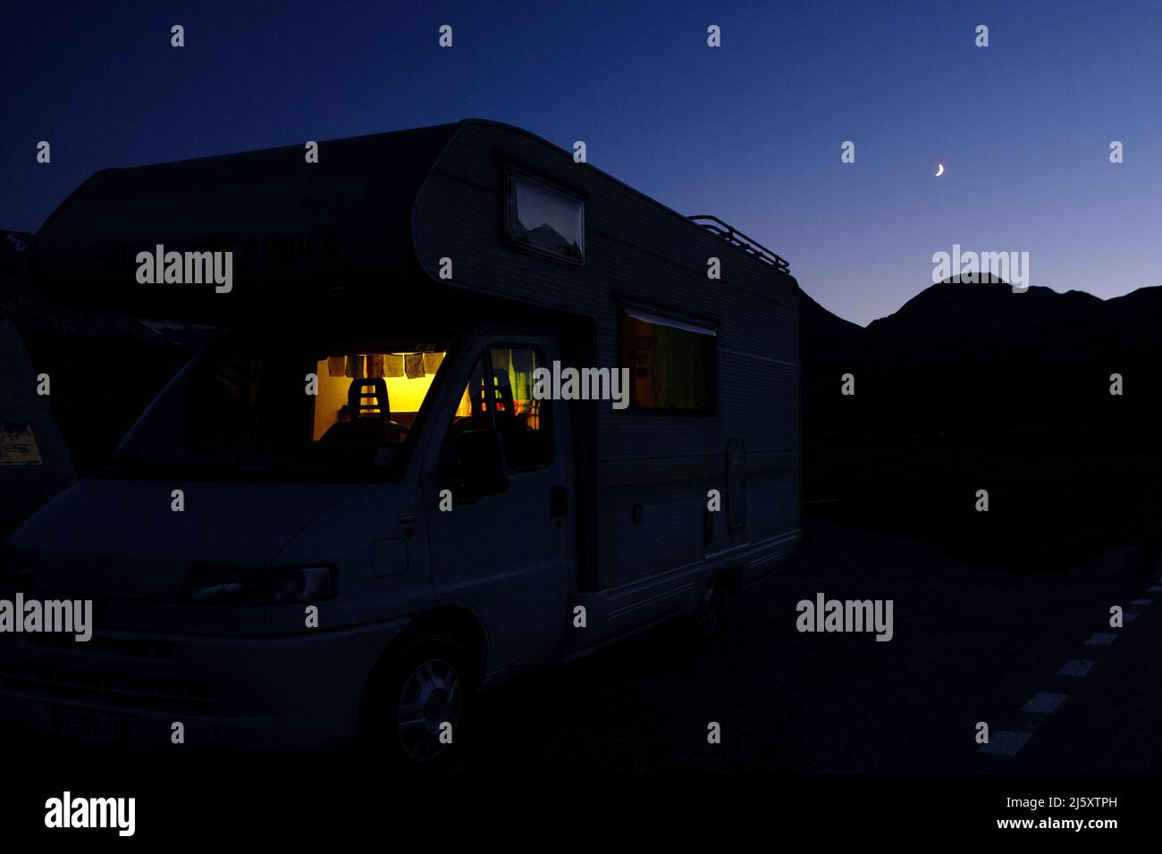 Retro camper parked by the mountains during the night Stock Photo - Alamy