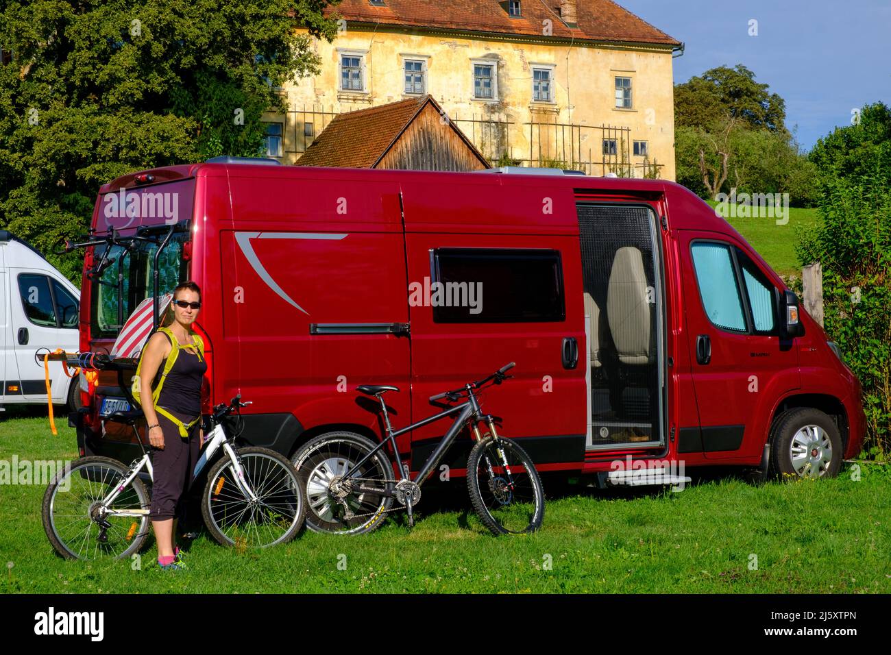 Red camper van parked in a field in Novo Mesto, Slovenia Stock Photo