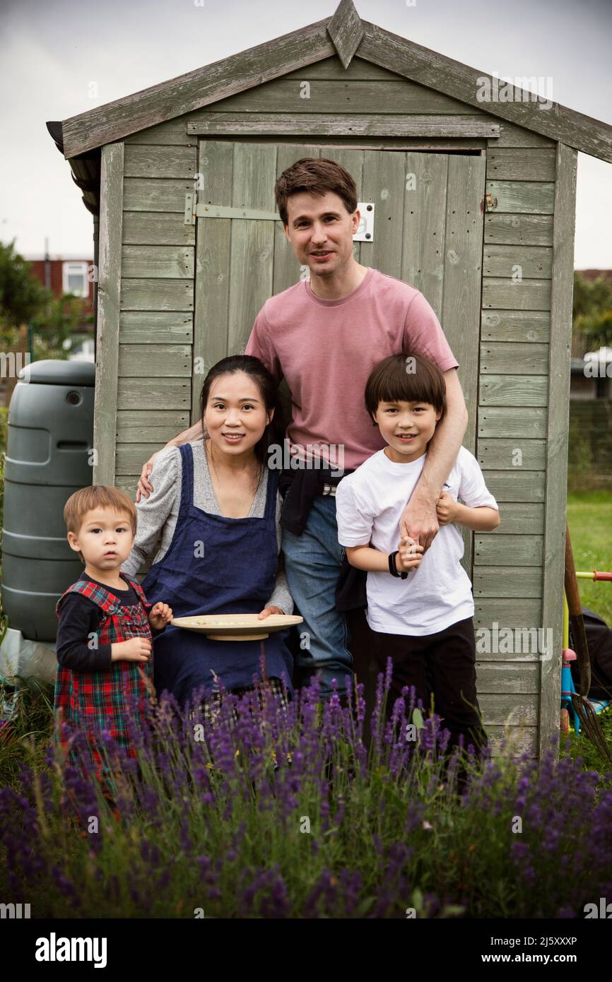 Portrait happy family at garden shed Stock Photo
