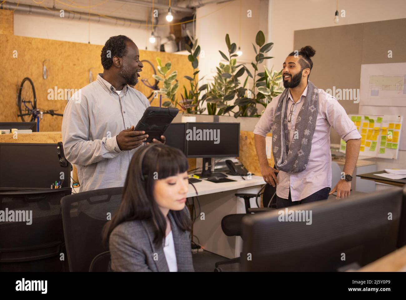 Business people talking in open plan office Stock Photo - Alamy