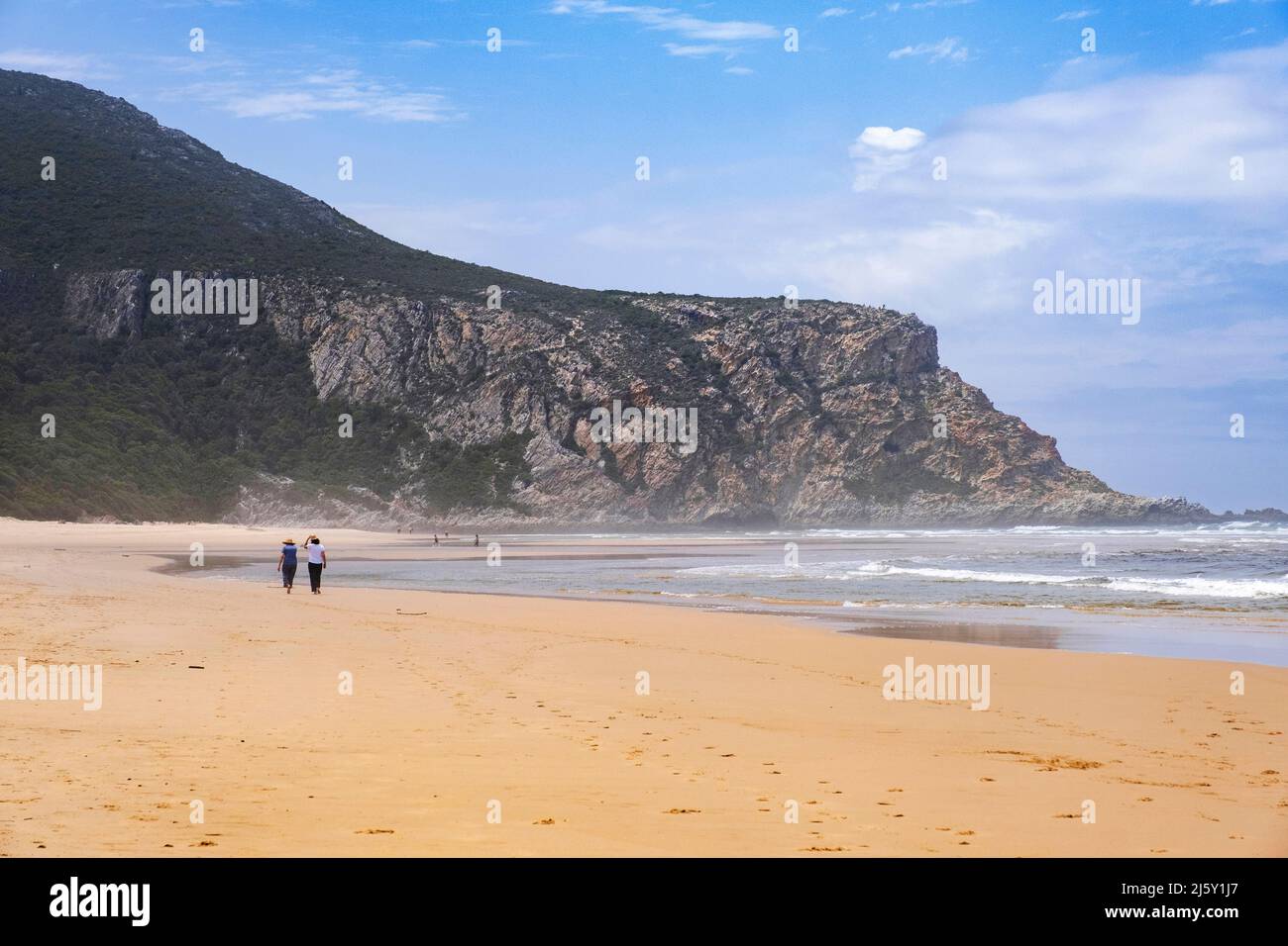 Tourists walking on Nature's Valley sandy beach in the Tsitsikamma Section of the Garden Route National Park, De Vasselot, Western Cape, South Africa Stock Photo