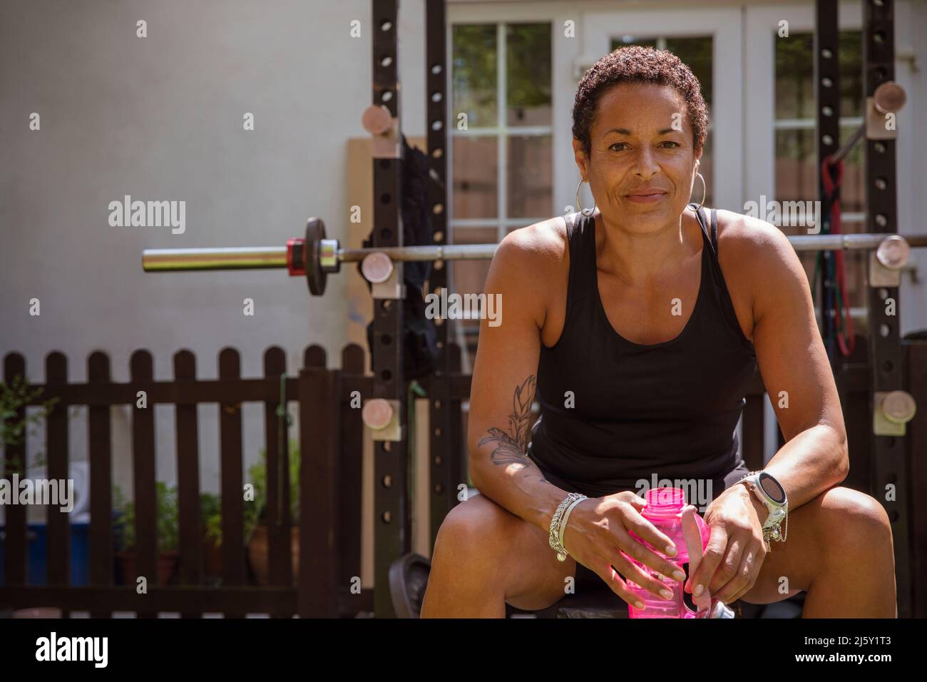 Portrait confident, dedicated mature woman working out in backyard Stock Photo