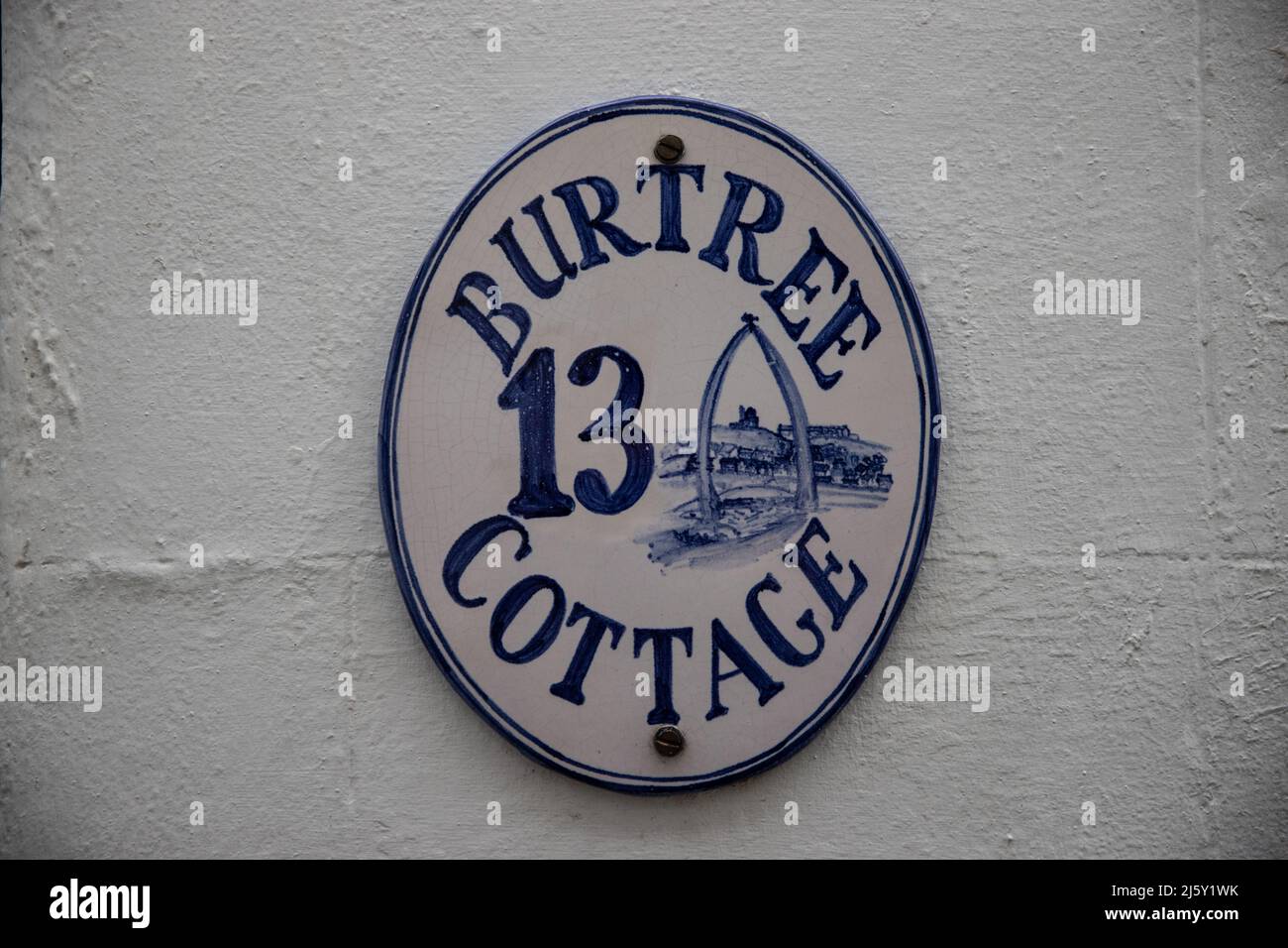 WHITBY, ENGLAND, UK. April 25th 2022. Close up view of a sign on a cottage in Whitby town centre's narrow side streets. Stock Photo