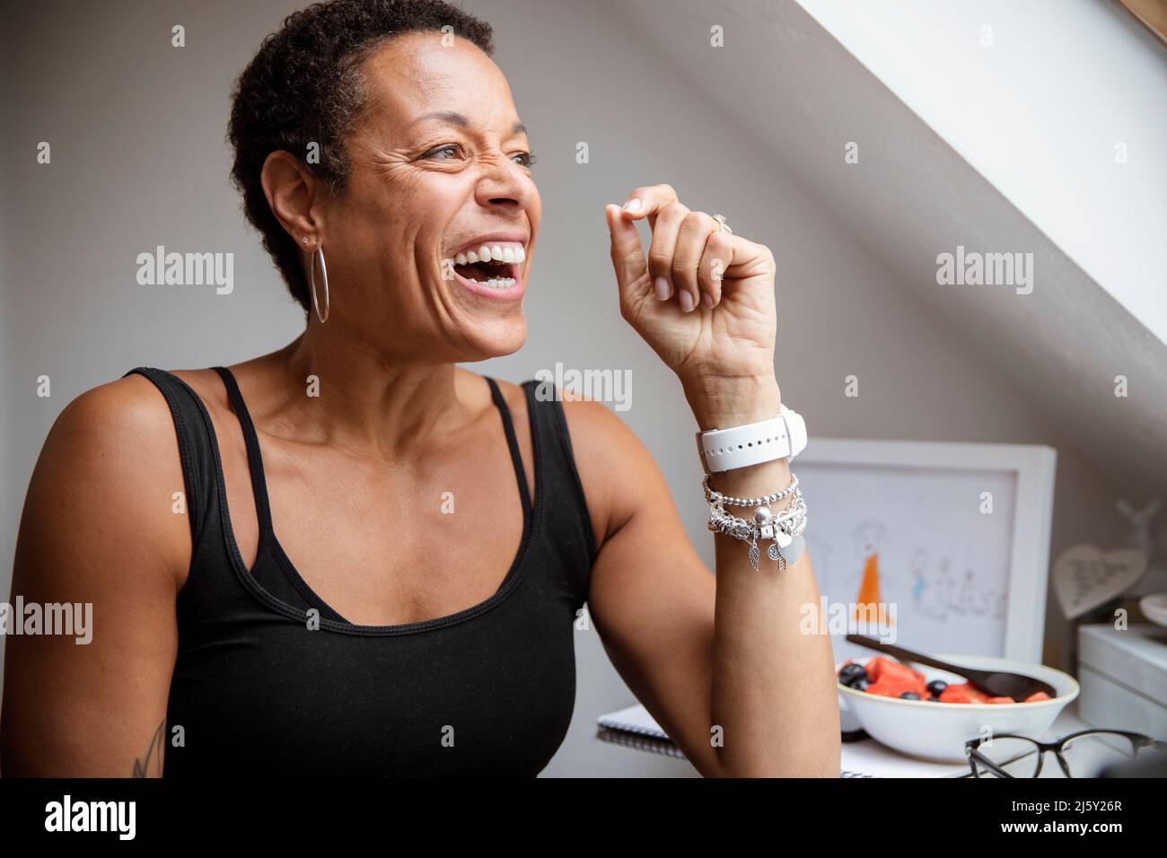 Happy mature woman laughing and looking away Stock Photo