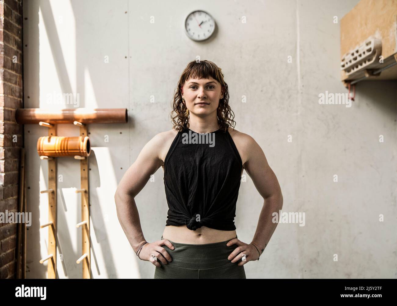 Confident woman standing in gym hi-res stock photography and images - Alamy