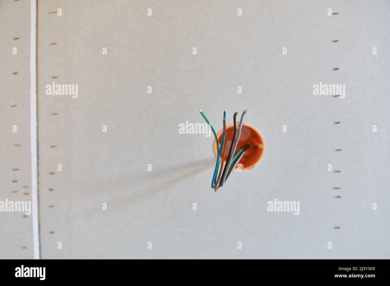 Power cables look out of the wall during electrical installation when