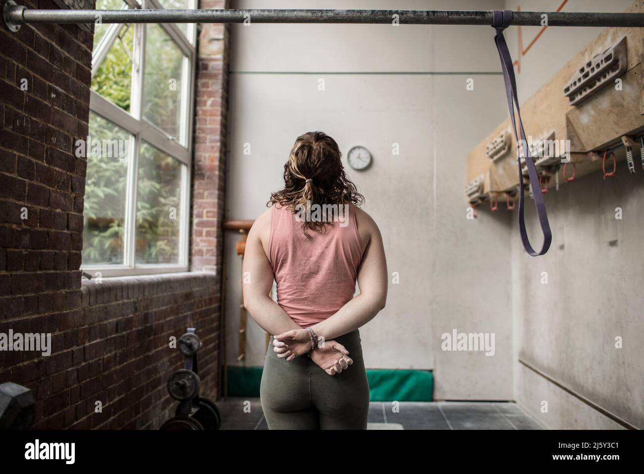 Dedicated young woman exercising in gym Stock Photo