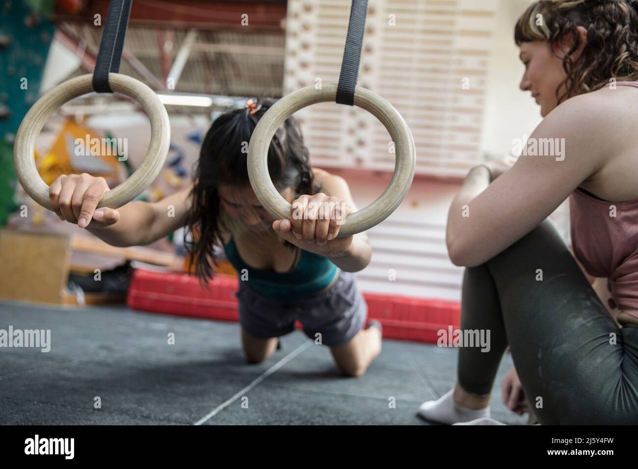 Female rock climbers training in climbing gym Stock Photo