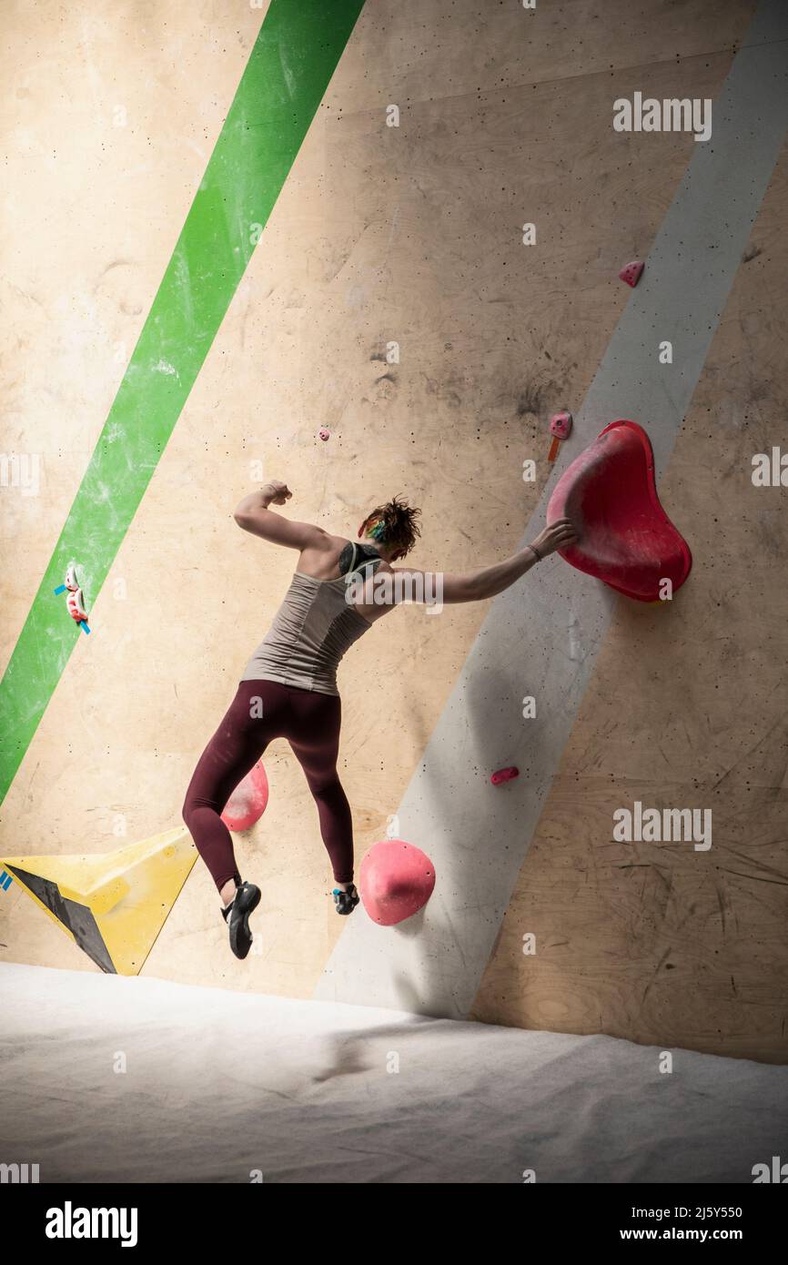 Female rock climber jumping from climbing wall Stock Photo Alamy