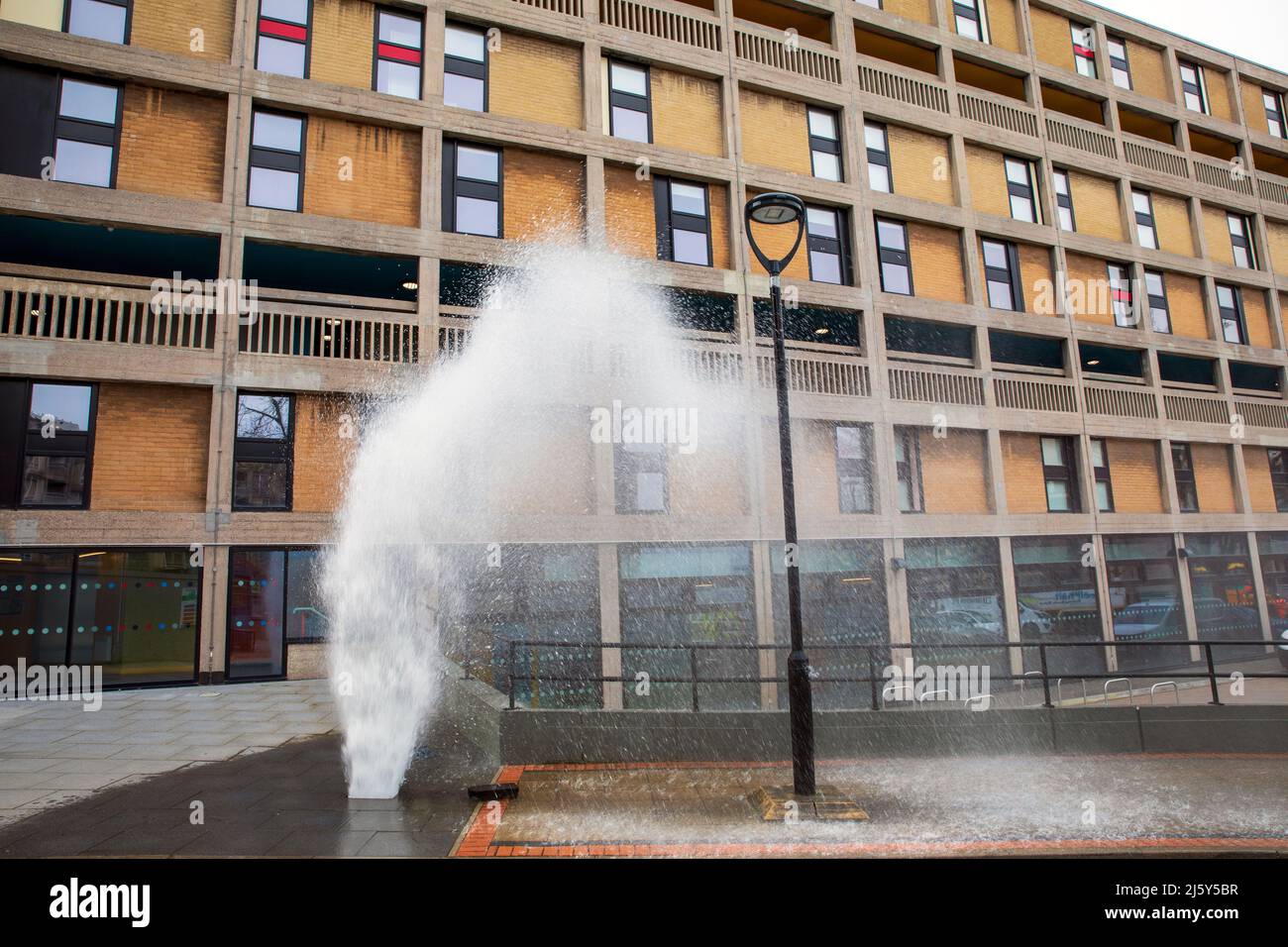 A burst water pipe. Hyde Park Flats, some of which are still under renovation, Sheffield. Stock Photo