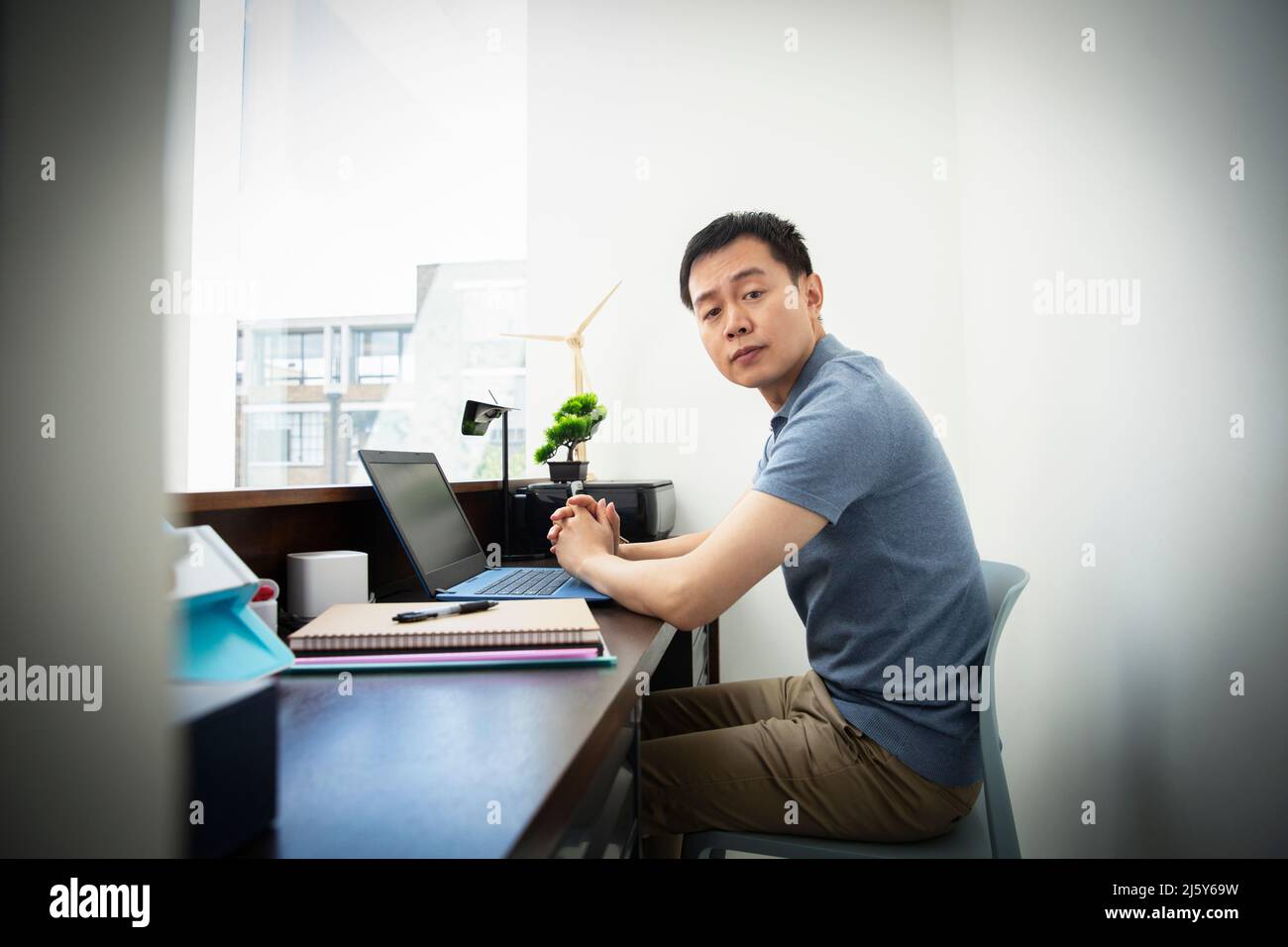 Portrait confident male engineer working at laptop in office Stock Photo