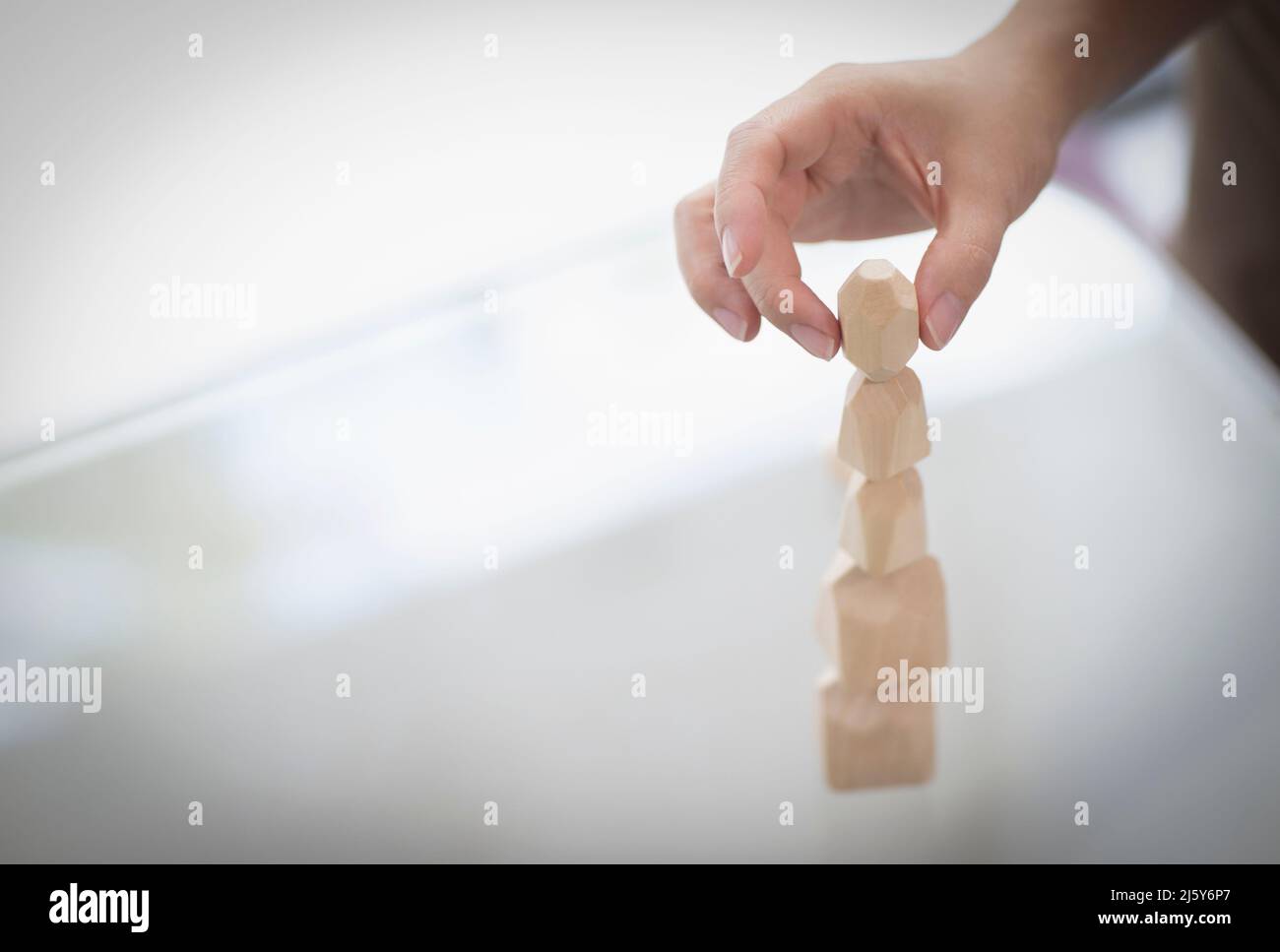 Close up hand of man stacking wooden pieces Stock Photo