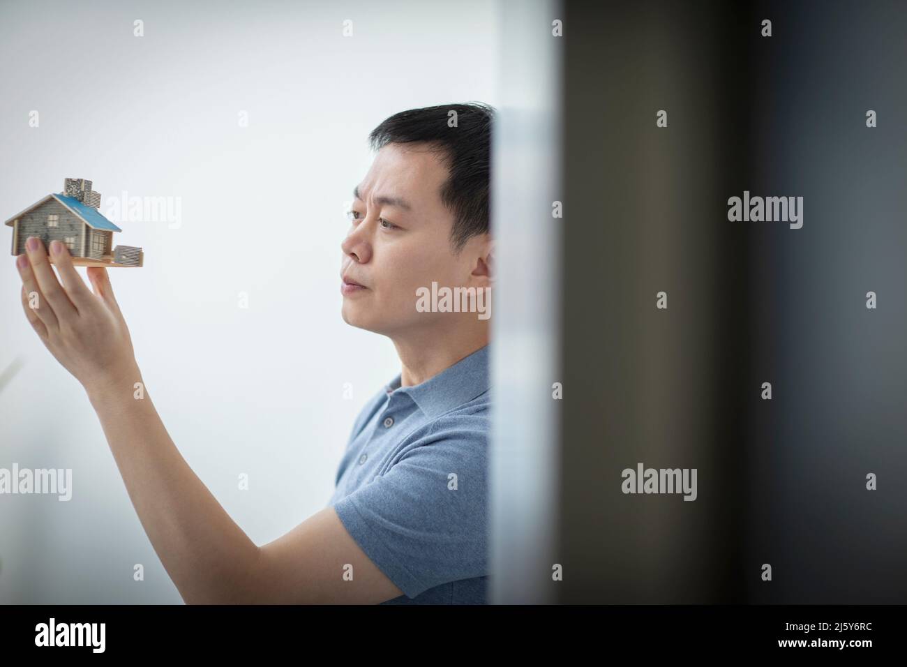 Male architect inspecting house model Stock Photo
