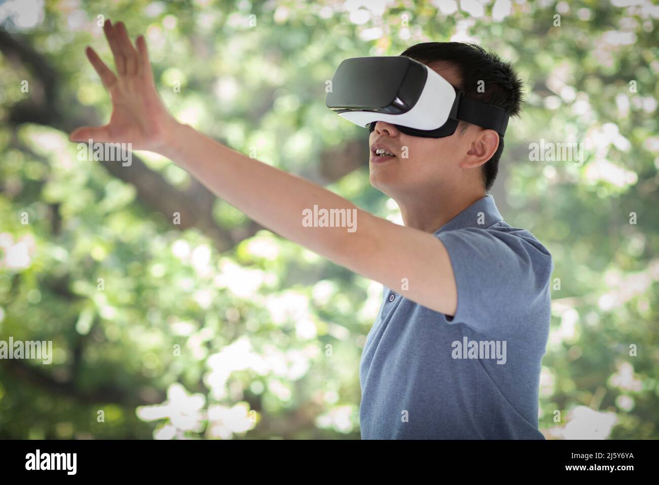 Man gesturing, using VR headset Stock Photo