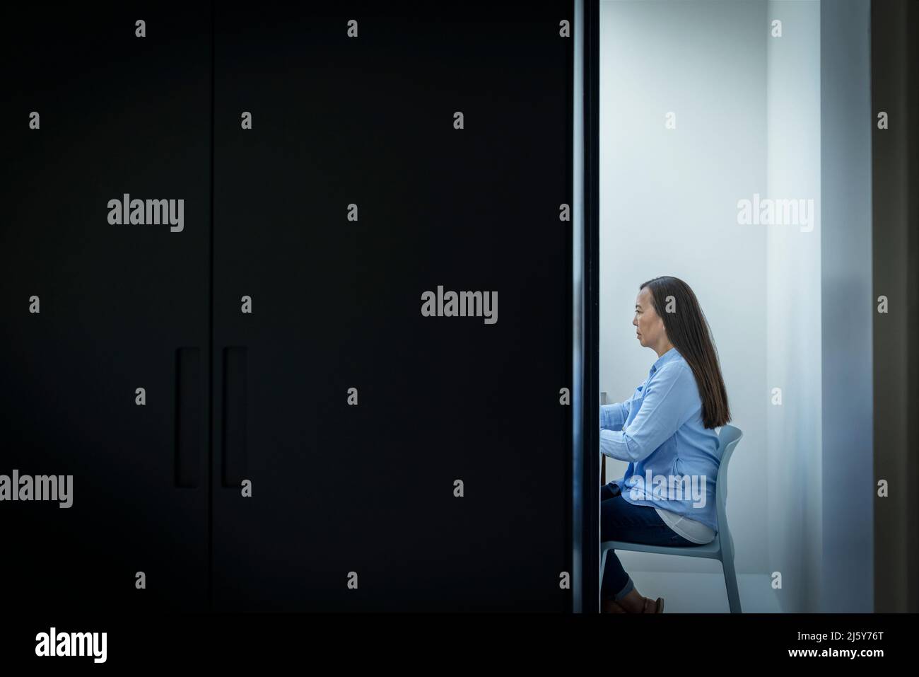 Businesswoman working in office doorway Stock Photo