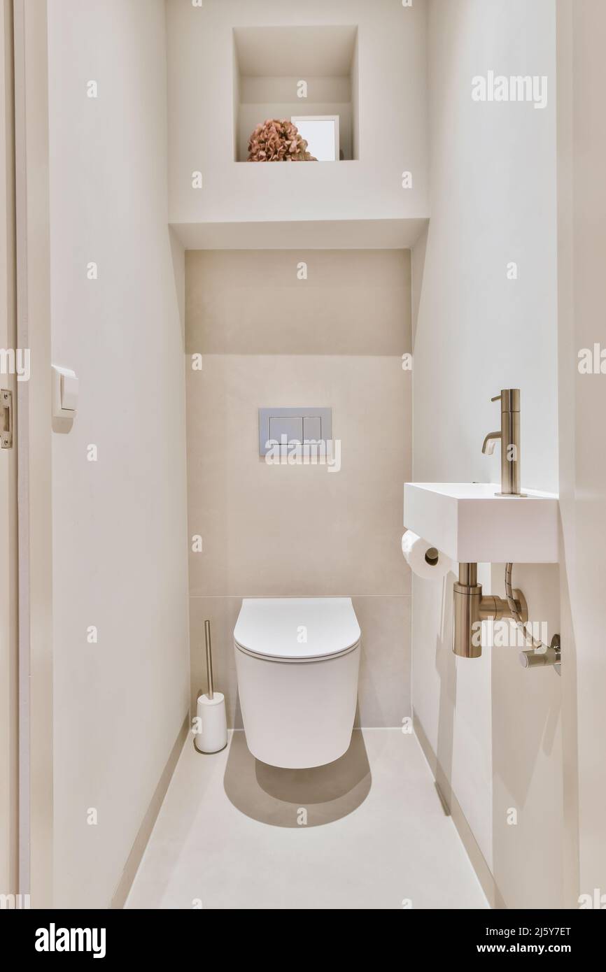 Toilet placed at wall in light small bathroom at home Stock Photo Alamy