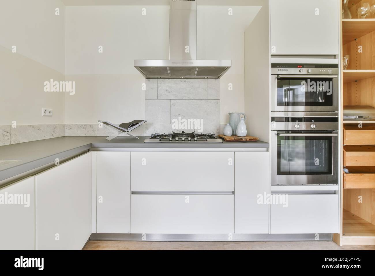 Contemporary built in ovens placed near counter in modern kitchen with