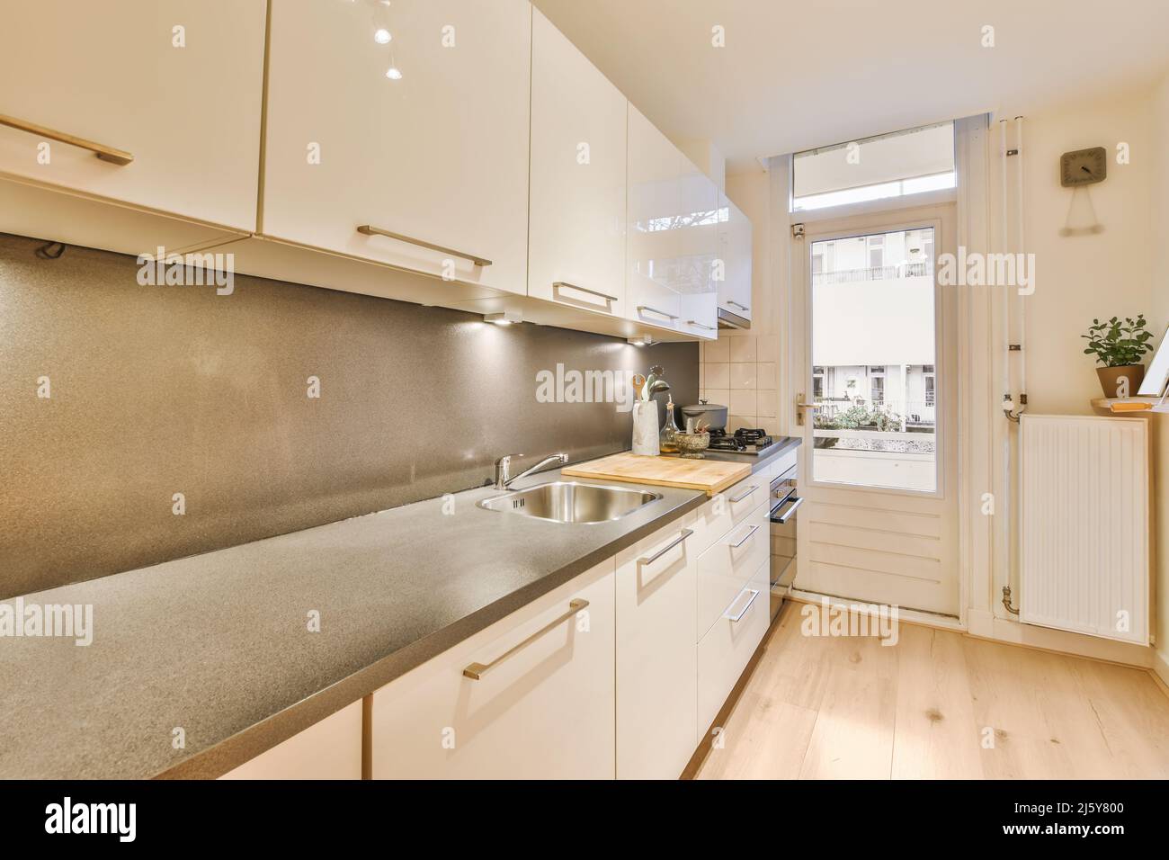 Interior of modern kitchen with cabinets and cupboards with appliances ...