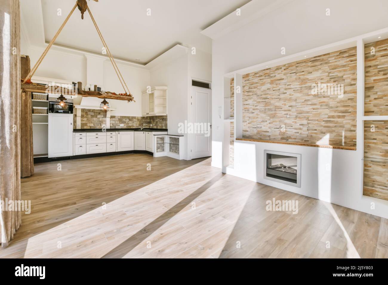 Interior of spacious kitchen with white cupboards and built in