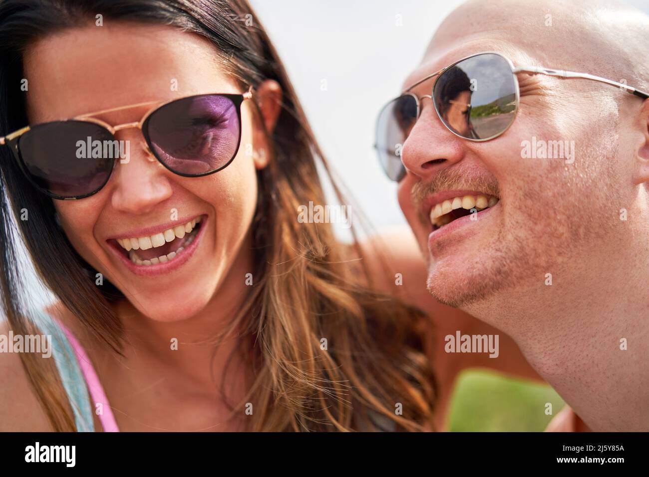 Close up happy couple in sunglasses laughing Stock Photo