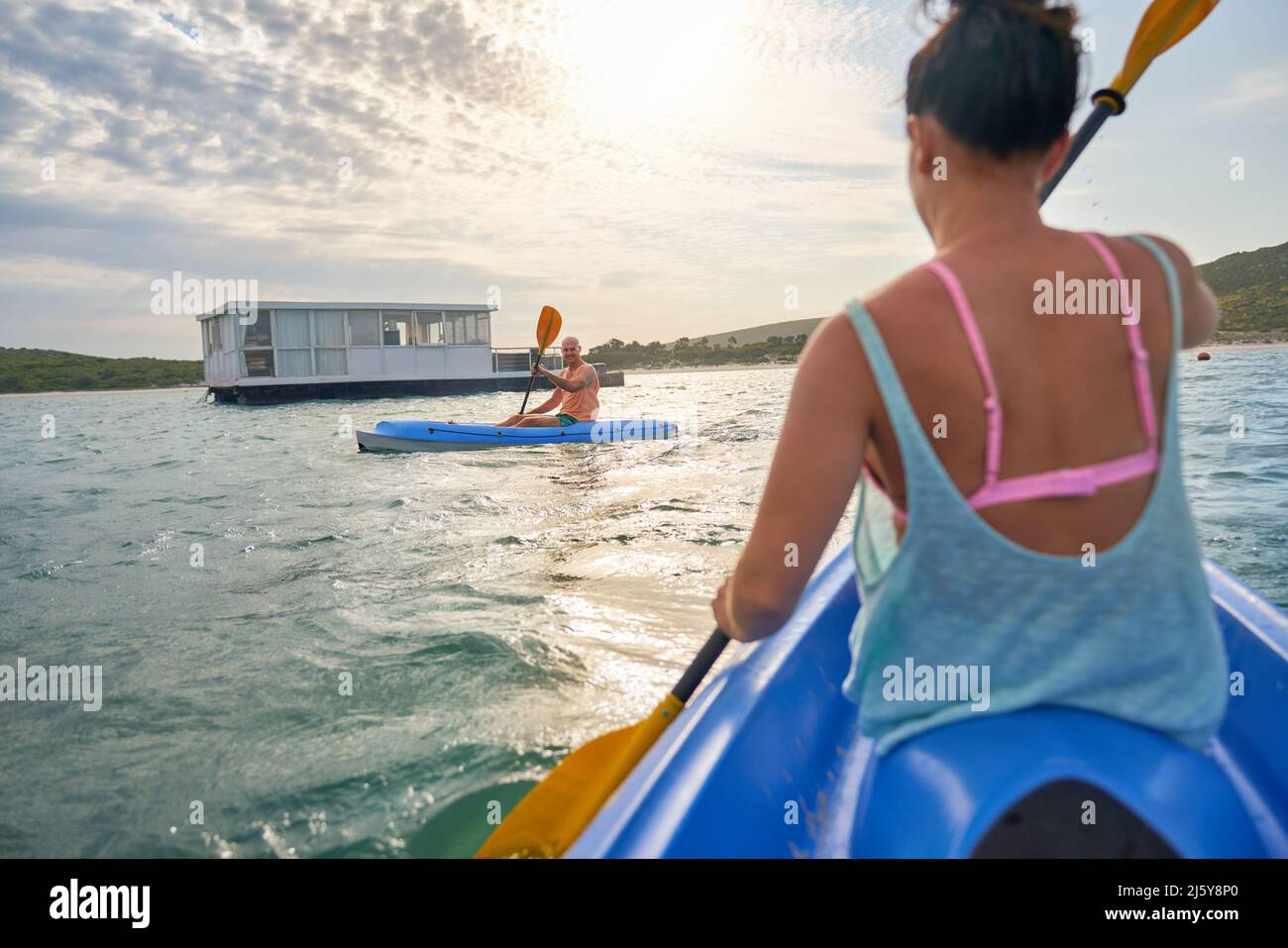 Couple kayaking on sunny summer lake Stock Photo