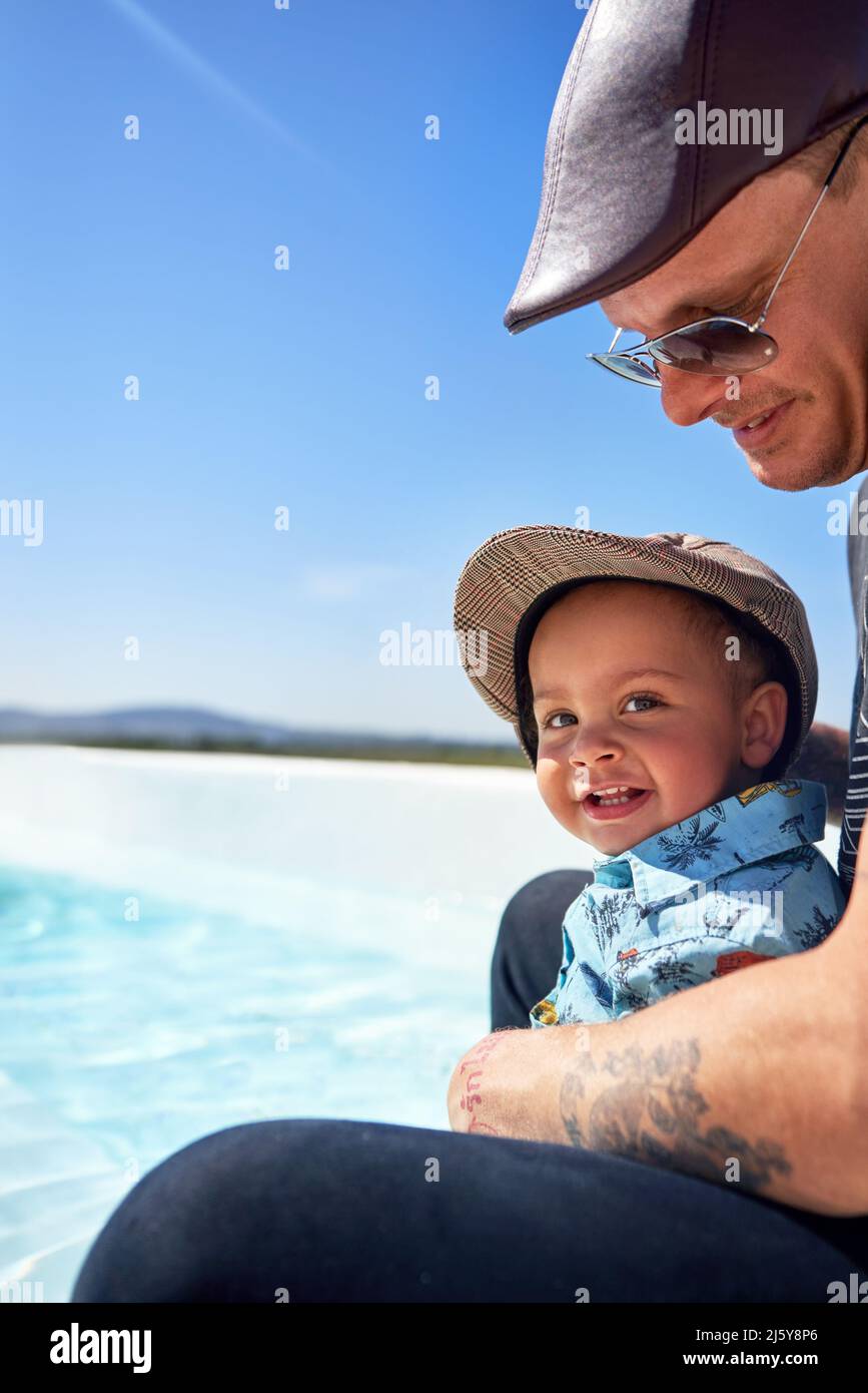 Portrait cute toddler boy with father on sunny beach Stock Photo Alamy