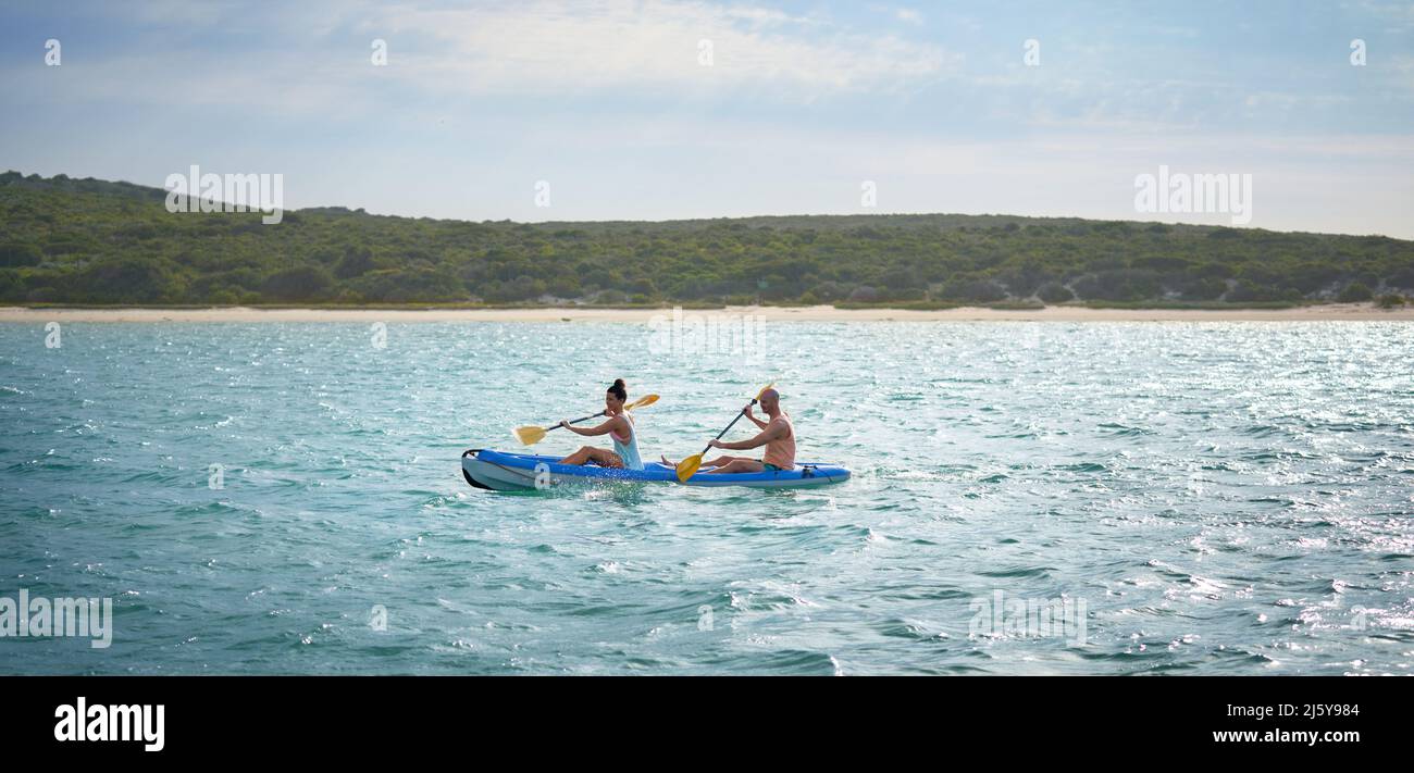 Couple kayaking on sunny summer lake Stock Photo