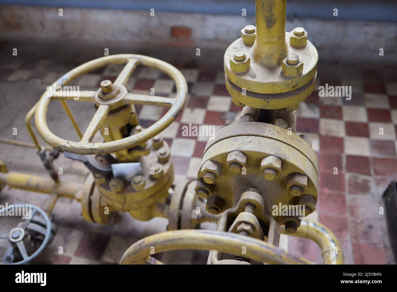 Close-up at pipeline valve which is using to control production process ...