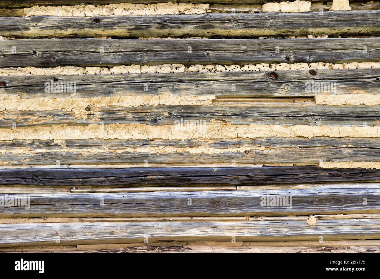 Background close up of a log wall of an exterior building. Stock Photo