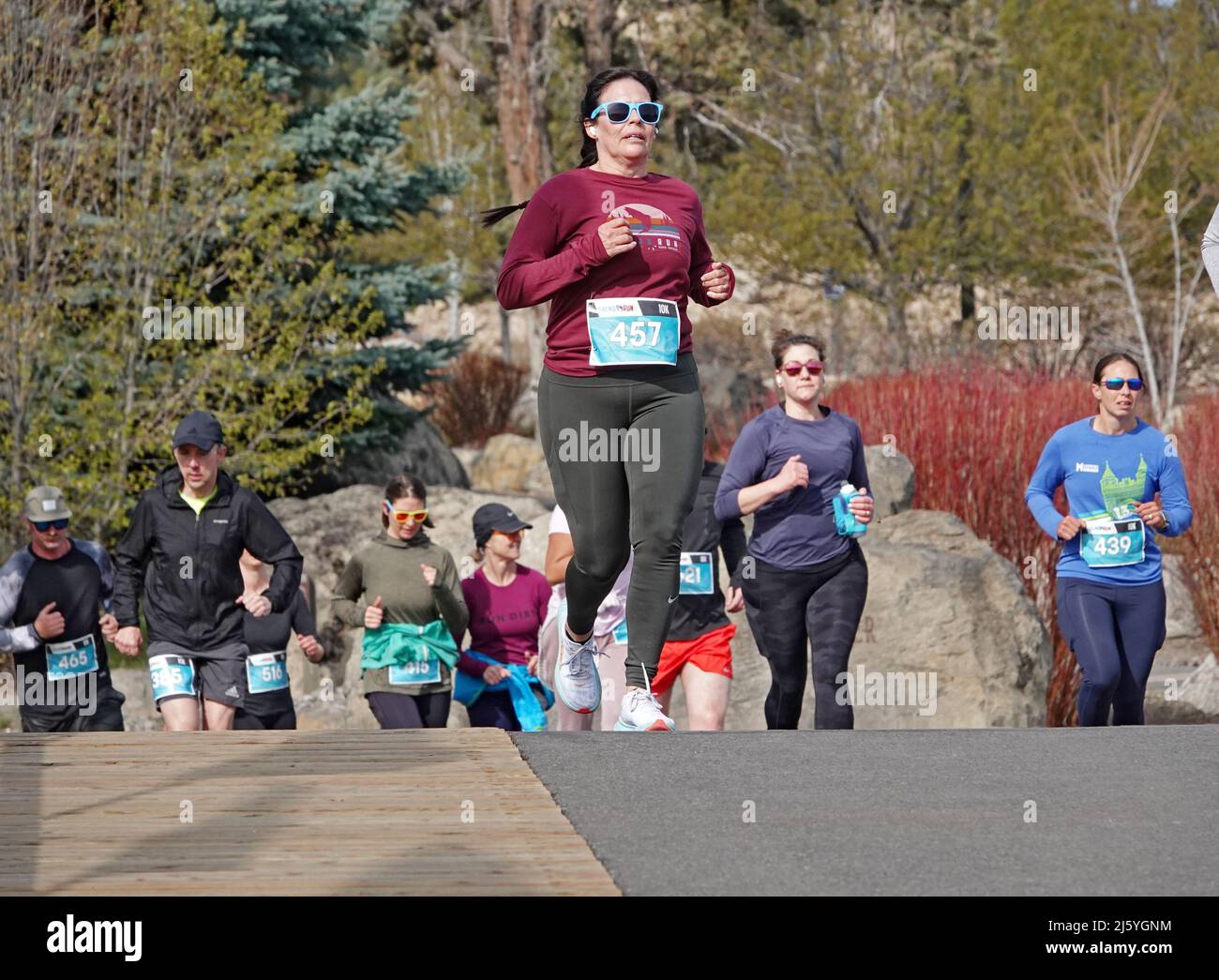 Runners in the annual Salmon Run, a charity event held each spring in the Old Mill District of Bend, Oregon. Stock Photo