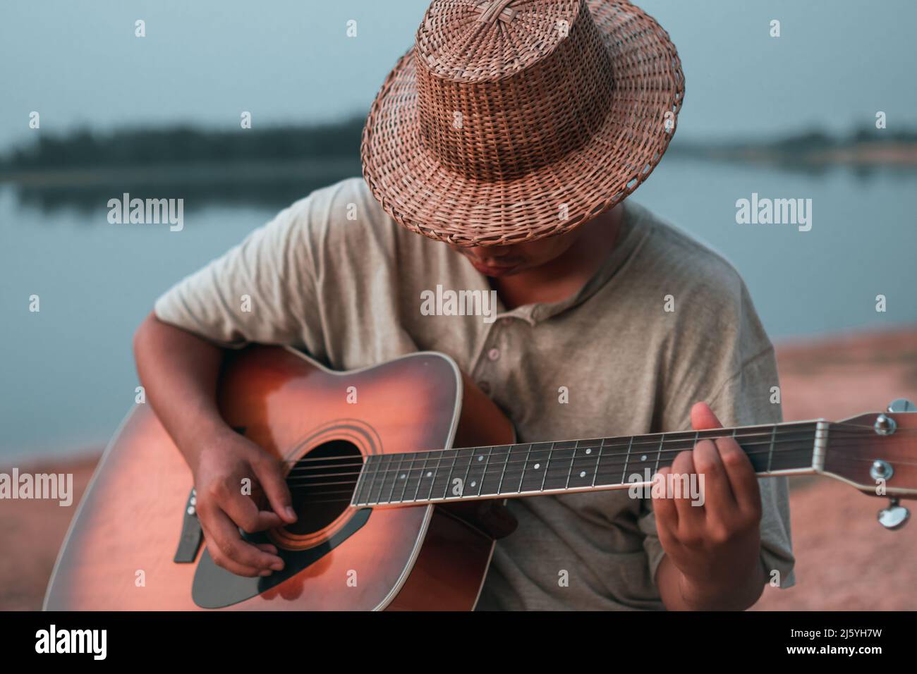 Young artists are happy to enjoy playing guitar Stock Photo