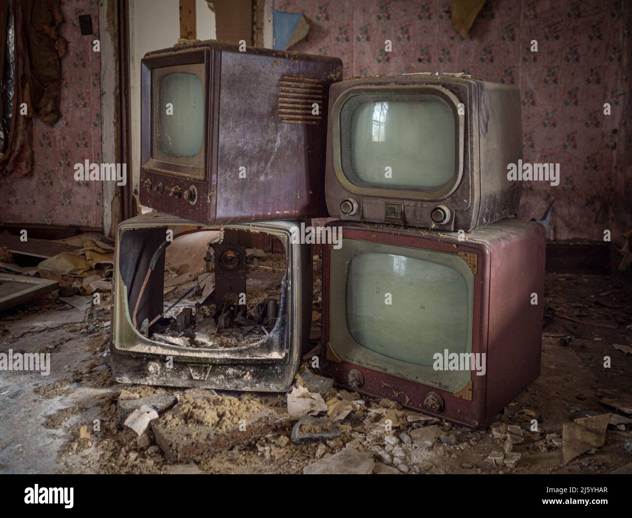 Old TV and chair  in an abandoned house. Stock Photo