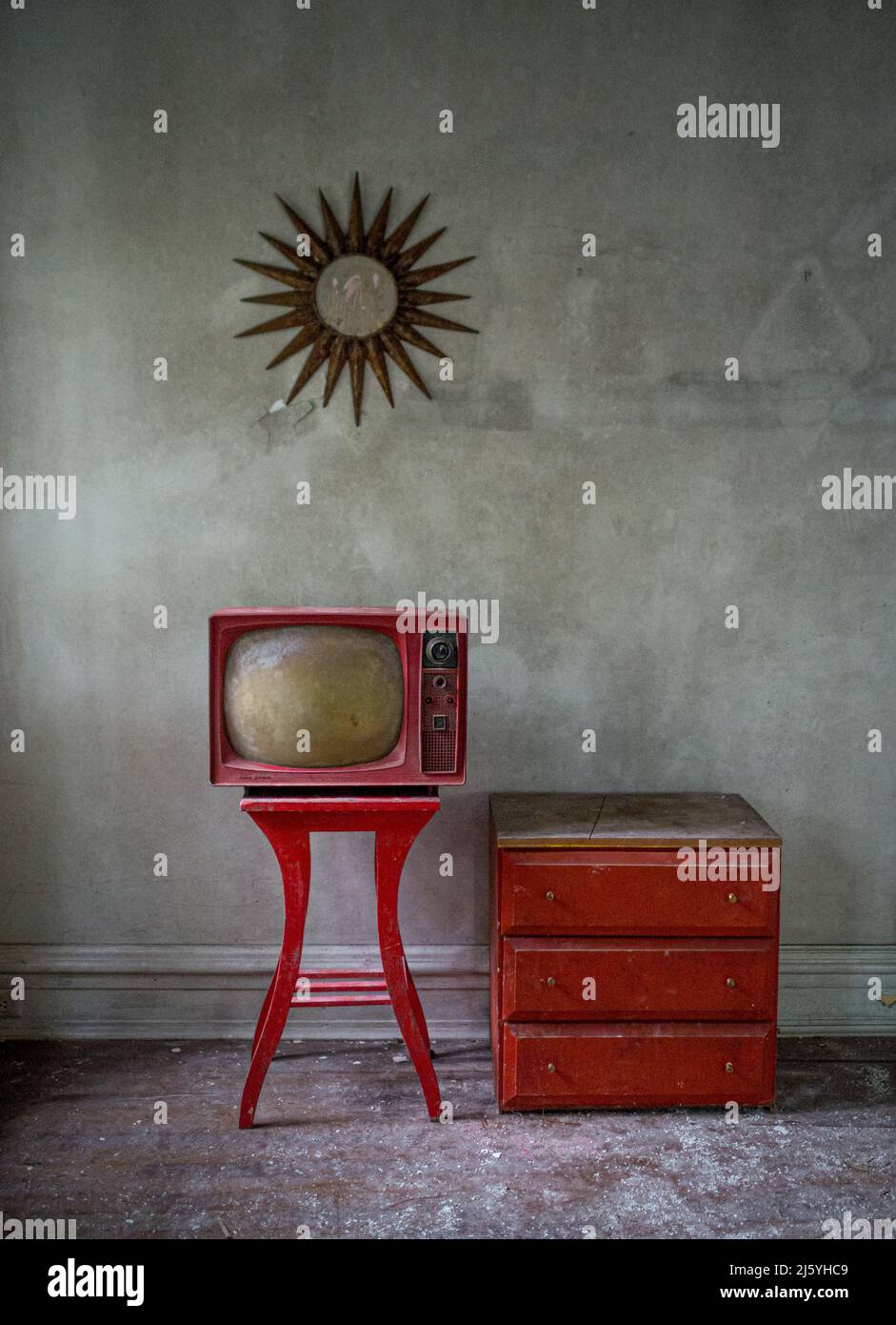 Old TV and chair  in an abandoned house. Stock Photo