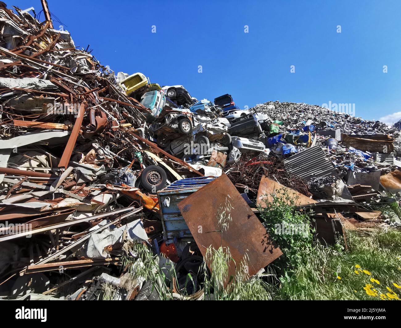 Pile of various scrap cars and other metals on a junk yard ready recycling industry. Stock Photo